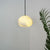 Hand‑Chiseled Galet Alabaster Brass Pendant Lamp – Sculptural Shine